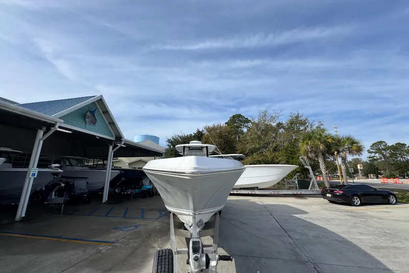 Slide: The Image of 2023 Fountain 38 Tournament Edition boat on trailer, parked outdoors under blue sky. - 7