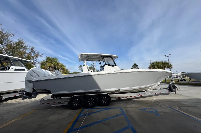 Slide: The Image of 2023 Fountain 38 Tournament Edition boat on trailer, parked outdoors under blue sky. - 9