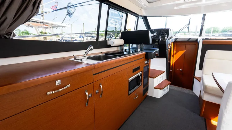 Slide: The Image of Interior of 2018 Jeanneau NC11 yacht with modern kitchen and helm station. - 19