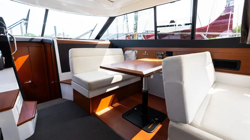 Slide: The Image of Interior of 2018 Jeanneau NC11 yacht with modern seating and dining area. - 23