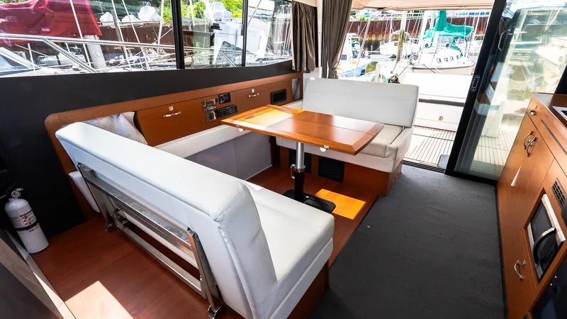 Slide: The Image of Interior of 2018 Jeanneau NC11 yacht with modern seating and dining area. - 25
