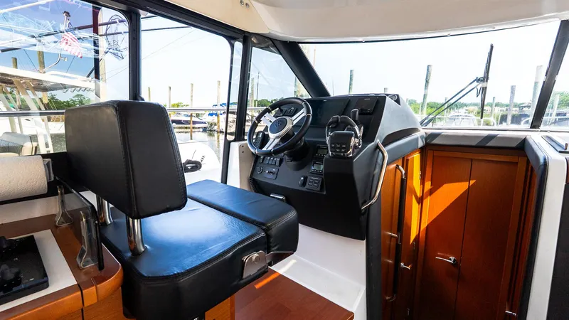 Slide: The Image of 2018 Jeanneau NC11 boat interior with steering wheel and control panel. - 28