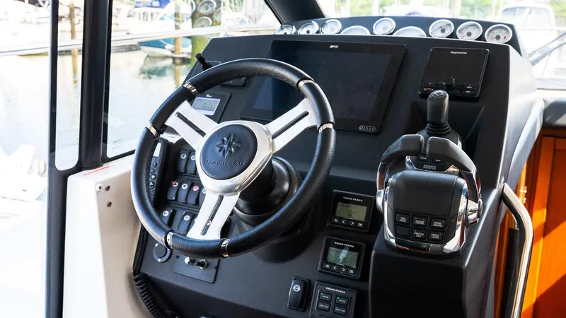 Slide: The Image of 2018 Jeanneau NC11 boat dashboard with steering wheel and controls. - 31