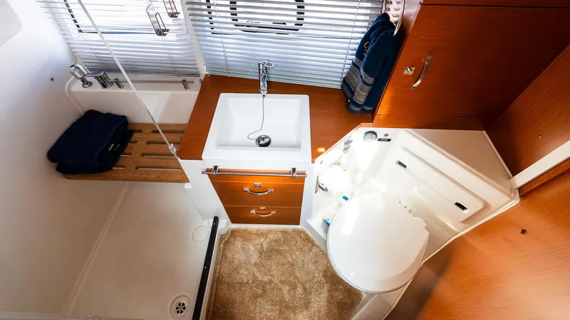 Slide: The Image of 2018 Jeanneau NC11 bathroom with sink, shower, and wooden cabinetry. - 35