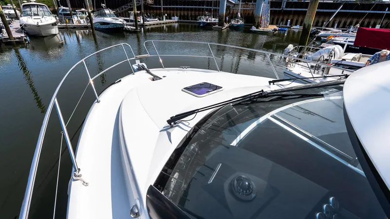 Slide: The Image of 2018 Jeanneau NC11 boat docked in a marina, showcasing sleek design and spacious deck. - 37