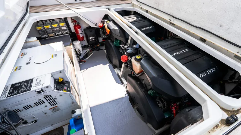 Slide: The Image of Engine compartment of a 2018 Jeanneau NC11 boat, featuring dual Volvo Penta D3-200 engines. - 8