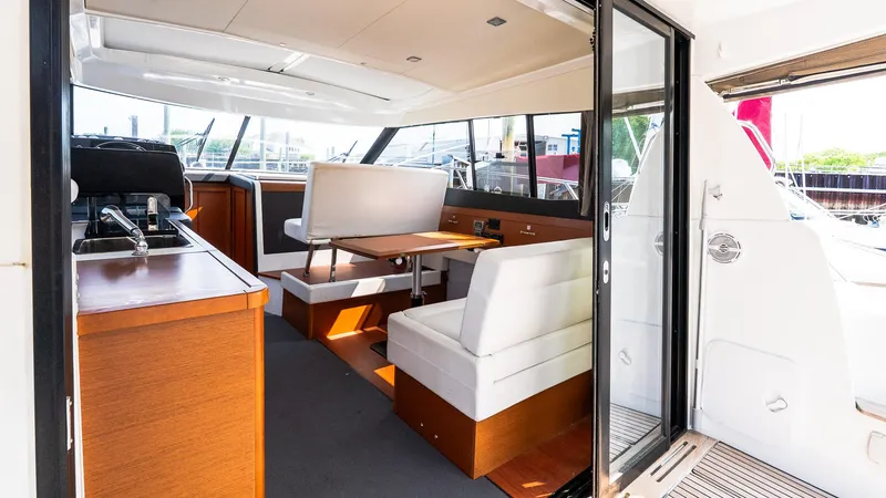 Slide: The Image of Interior of 2018 Jeanneau NC11 yacht with modern seating and dining area. - 9