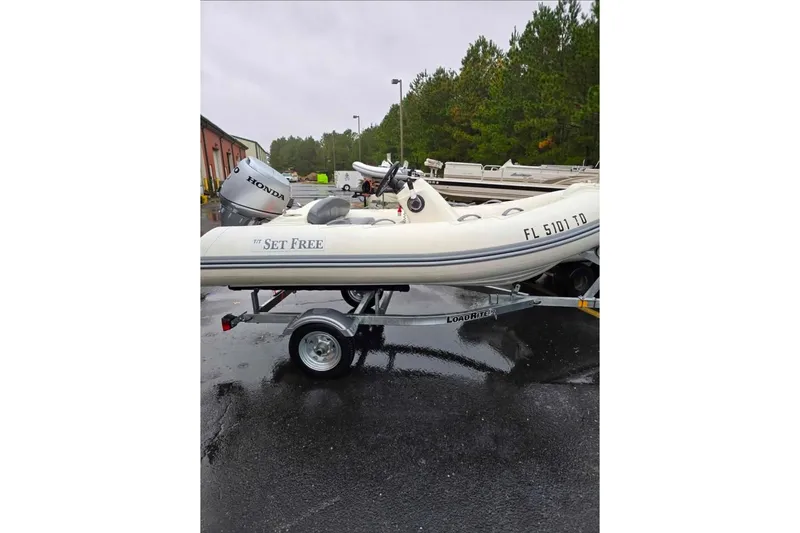 The Image of 2021 Brig Eagle 340 inflatable boat on trailer with Honda outboard motor. - 1