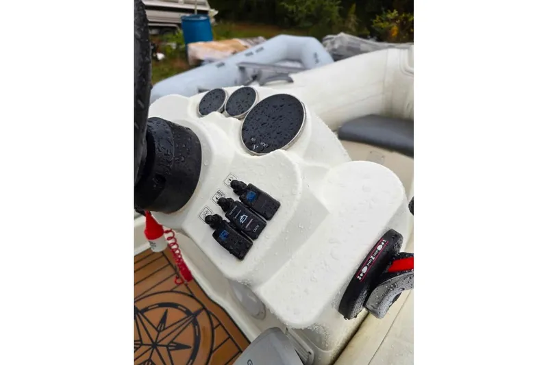 Slide: The Image of 2021 Brig Eagle 340 boat dashboard with controls and steering wheel. - 7