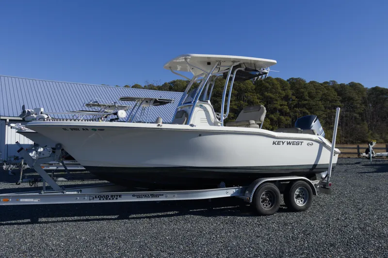 The Image of 2022 Key West 219 FS boat on trailer, parked outdoors. - 0
