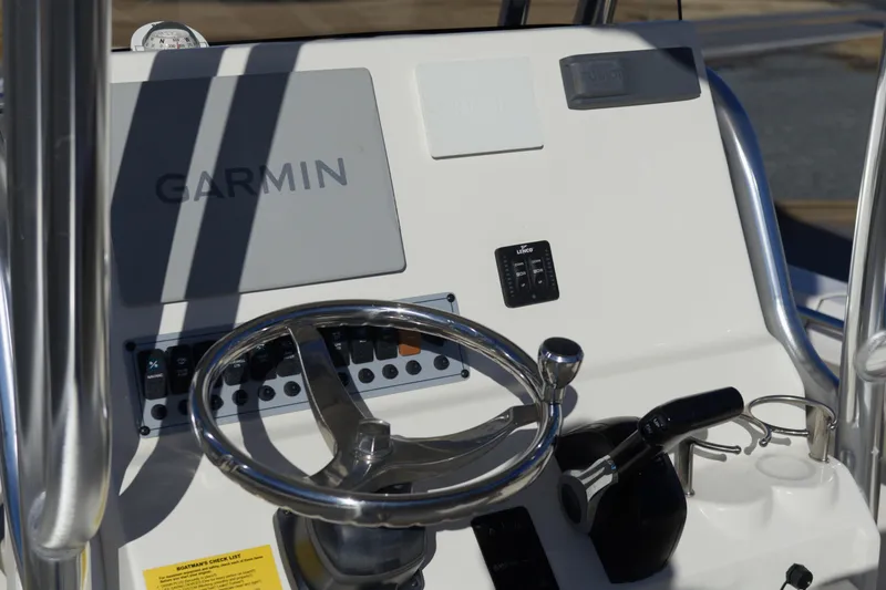 Slide: The Image of 2022 Key West 219 FS boat console with Garmin navigation system and steering wheel. - 10