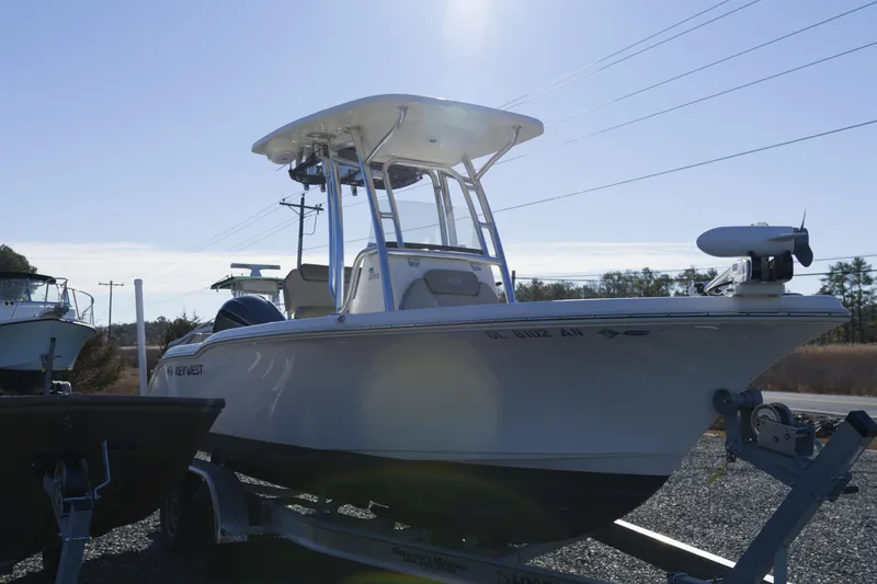Slide: The Image of 2022 Key West 219 FS boat on trailer under clear sky. - 3