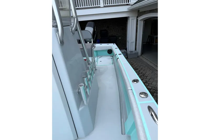 Slide: The Image of 2019 Latitude Tournament Boats 25, sleek interior view with rod holders and seating. - 10