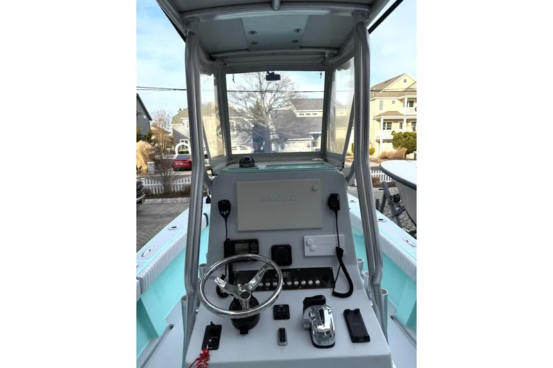 Slide: The Image of 2019 Latitude Tournament Boats 25 cockpit with steering wheel and controls. - 11