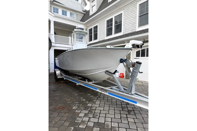 Slide: The Image of 2019 Latitude Tournament Boats 25 on trailer, parked on cobblestone driveway. - 3