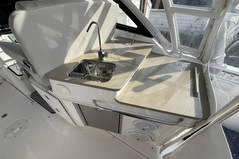 Slide: The Image of Interior of 2020 Everglades 340 Dual Console boat with sink and countertop. - 19