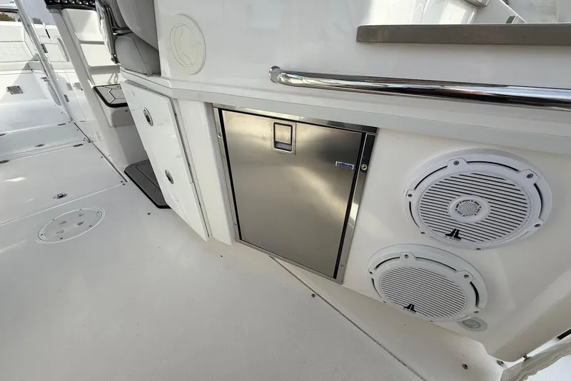 Slide: The Image of 2020 Everglades 340 Dual Console boat interior with speakers and stainless steel fridge. - 21