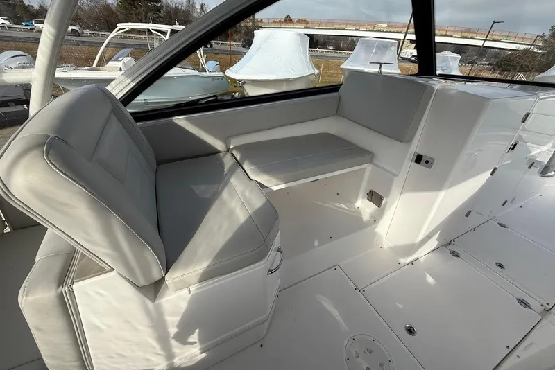 Slide: The Image of 2020 Everglades 340 Dual Console interior with gray seating and sleek design. - 23