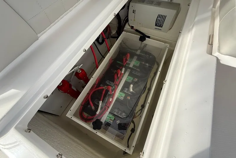 Slide: The Image of Battery compartment of 2020 Everglades 340 Dual Console boat, featuring wiring and equipment. - 24