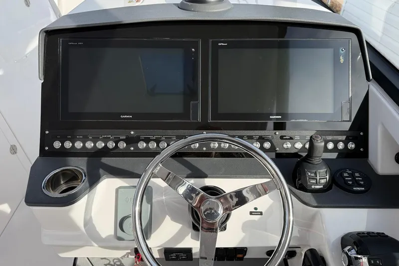Slide: The Image of Helm of 2020 Everglades 340 Dual Console with dual Garmin displays and controls. - 27