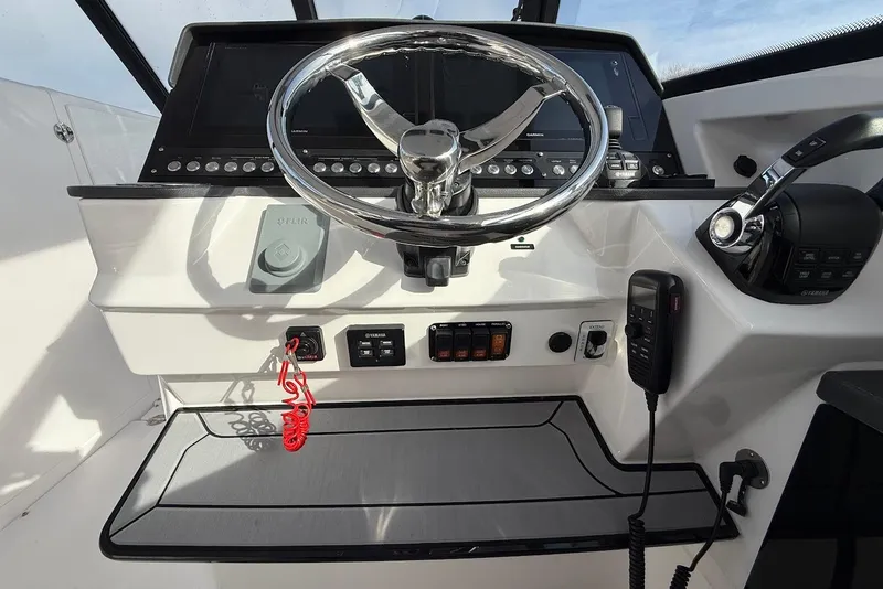 Slide: The Image of 2020 Everglades 340 Dual Console helm with steering wheel, controls, and navigation equipment. - 28