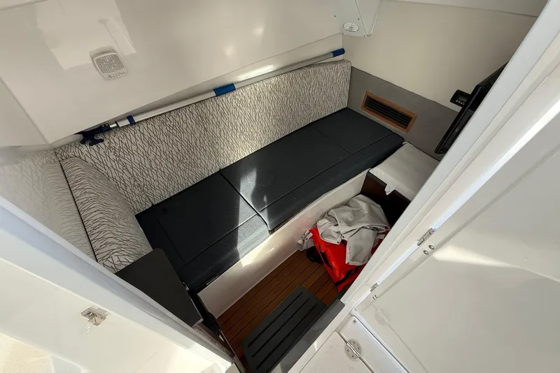 Slide: The Image of Interior cabin of 2020 Everglades 340 Dual Console boat, featuring seating and storage. - 30