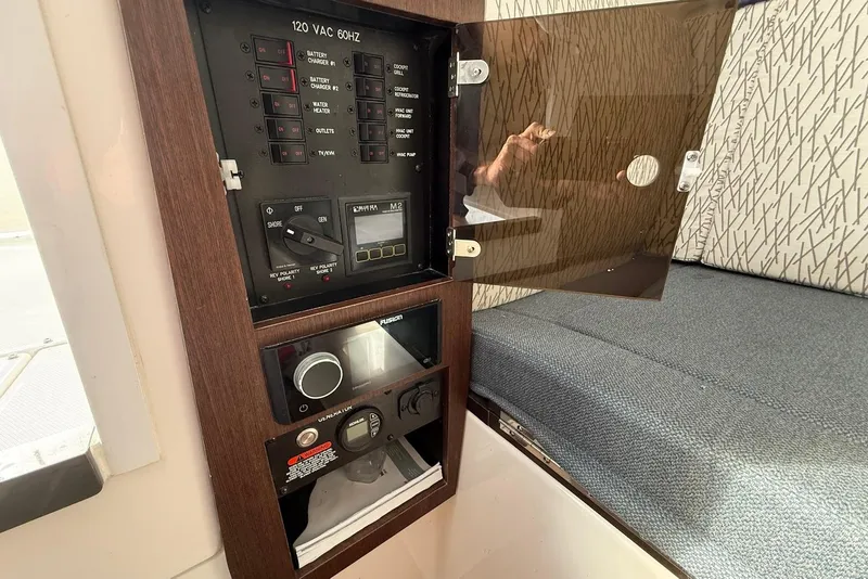 Slide: The Image of Electrical panel inside 2020 Everglades 340 Dual Console boat, featuring switches and controls. - 32