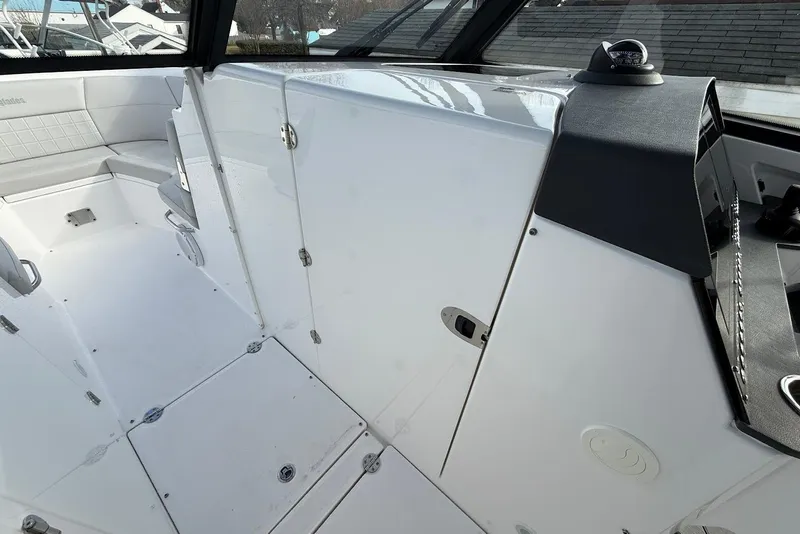 Slide: The Image of 2020 Everglades 340 Dual Console interior with sleek white seating and modern design. - 33