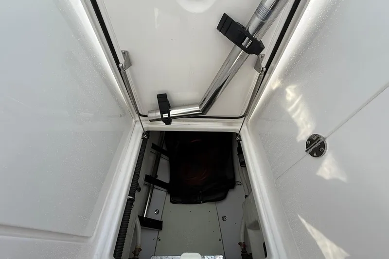 Slide: The Image of Storage compartment of 2020 Everglades 340 Dual Console boat, featuring secure latches and clean interior. - 38