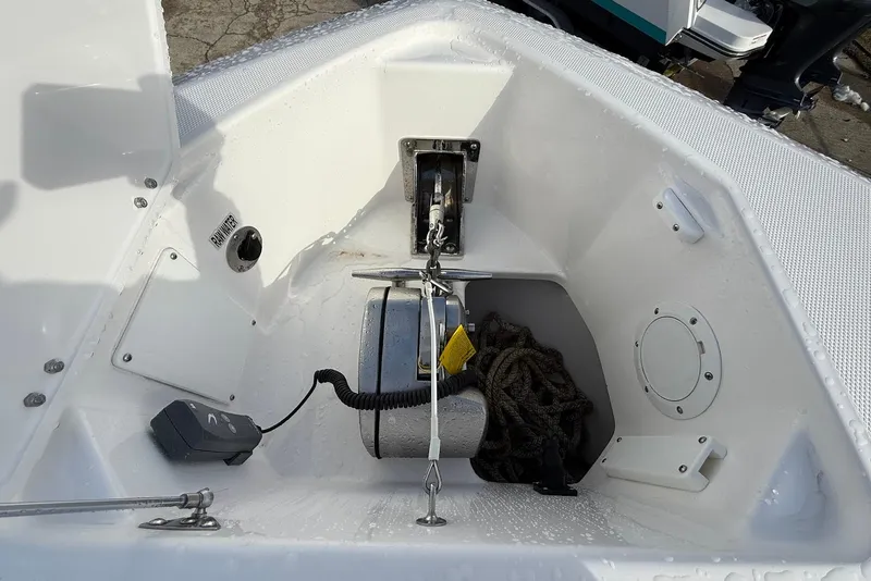 Slide: The Image of Bow anchor compartment of 2020 Everglades 340 Dual Console boat with rope and winch. - 42