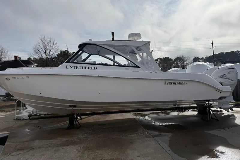Slide: The Image of 2020 Everglades 340 Dual Console boat on display, side view, outdoors. - 7