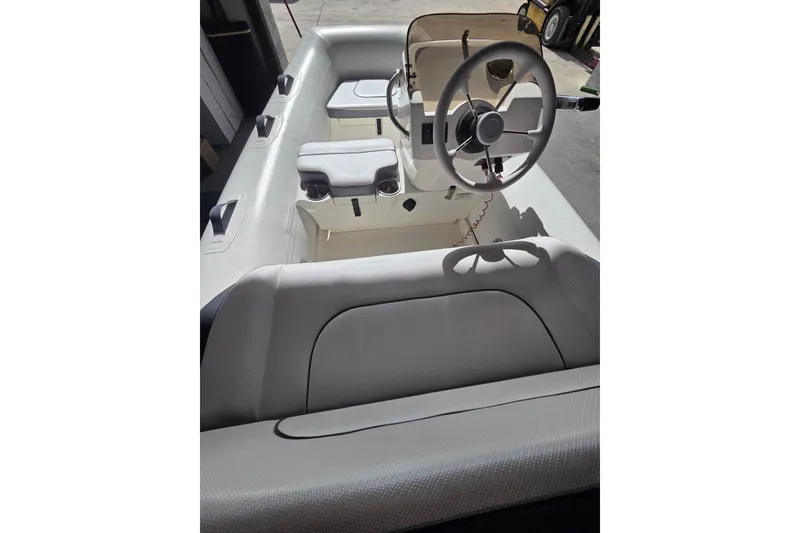 Slide: The Image of 2018 Walker Bay Supertender 365 interior with steering wheel and seating. - 5