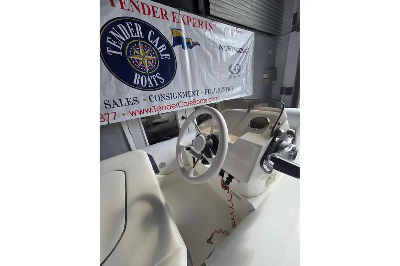 Slide: The Image of 2018 Walker Bay Supertender 365 boat interior with steering wheel and control panel. - 6