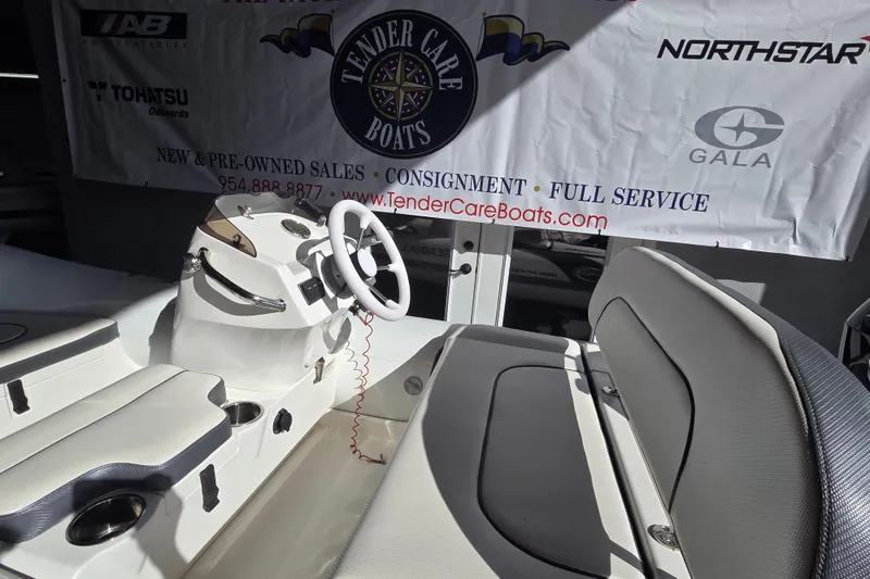 Slide: The Image of 2018 Walker Bay Supertender 365 boat interior with steering wheel and seating. - 3