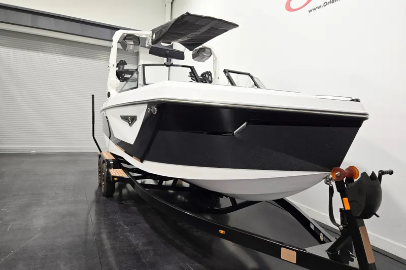 Slide: The Image of 2026 Nautique Super Air Nautique S23 boat on trailer in showroom. - 1