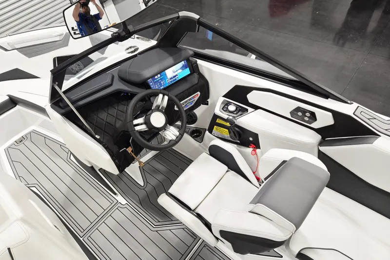 Slide: The Image of 2026 Nautique Super Air Nautique S23 cockpit with modern dashboard and steering wheel. - 5