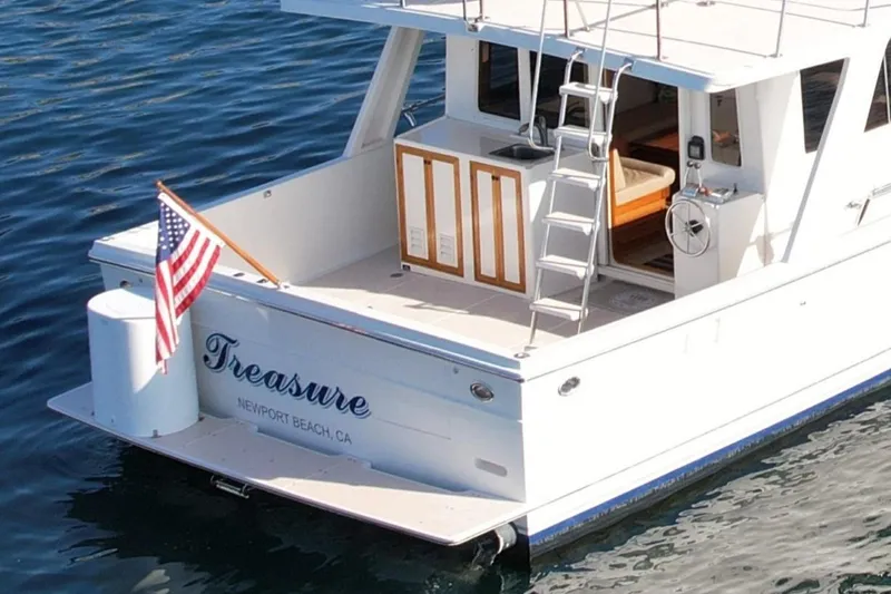 Slide: The Image of 1997 Offshore Yachts 48 Sedan, docked with American flag, Newport Beach, CA. - 12