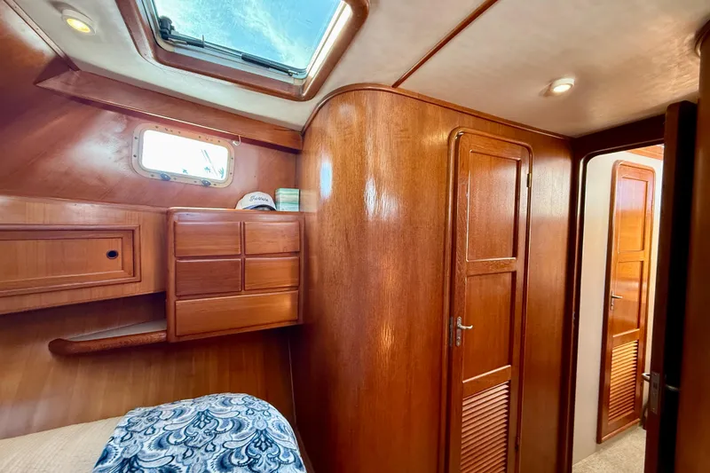 Slide: The Image of Interior of 1997 Offshore Yachts 48 Sedan with wooden cabinetry and skylight. - 16