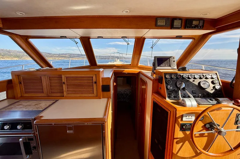 Slide: The Image of Interior view of 1997 Offshore Yachts 48 Sedan, featuring helm and ocean view. - 28