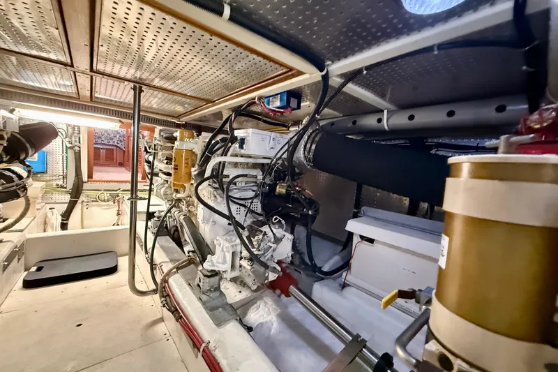 Slide: The Image of Engine room of a 1997 Offshore Yachts 48 Sedan, showcasing mechanical components and systems. - 82