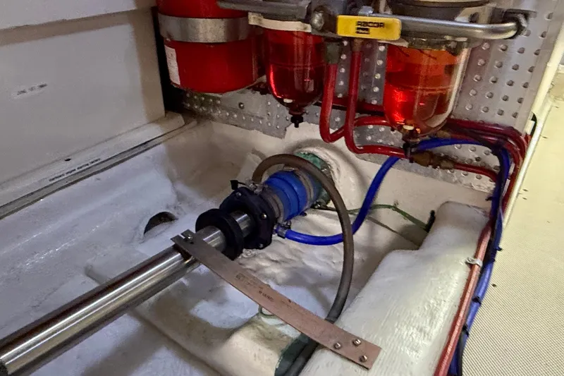 Slide: The Image of Engine room of 1997 Offshore Yachts 48 Sedan with visible fuel filters and piping. - 83