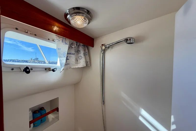 Slide: The Image of Shower area in 1997 Offshore Yachts 48 Sedan with window and curtain. - 19