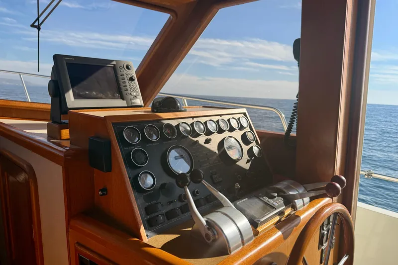 Slide: The Image of Helm of 1997 Offshore Yachts 48 Sedan with navigation equipment, overlooking the ocean. - 27
