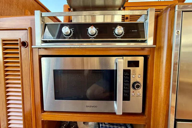 Slide: The Image of Galley kitchen in 1997 Offshore Yachts 48 Sedan with stove and microwave. - 44