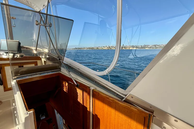 Slide: The Image of 1997 Offshore Yachts 48 Sedan interior with ocean view through windows. - 59
