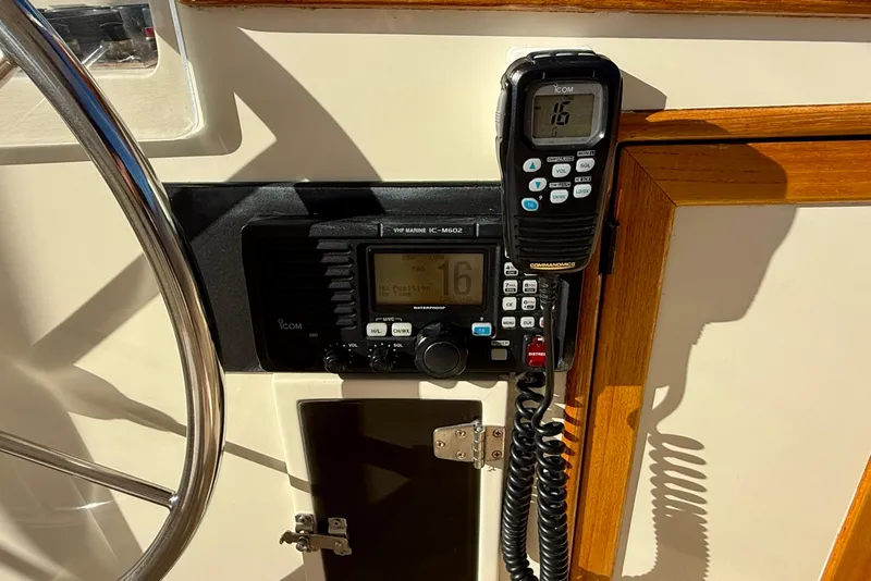 Slide: The Image of VHF marine radio on 1997 Offshore Yachts 48 Sedan, featuring Icom IC-M602 model. - 73