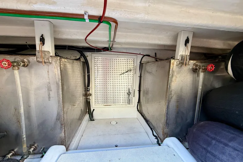 Slide: The Image of Engine room of 1997 Offshore Yachts 48 Sedan with metal tanks and piping. - 78