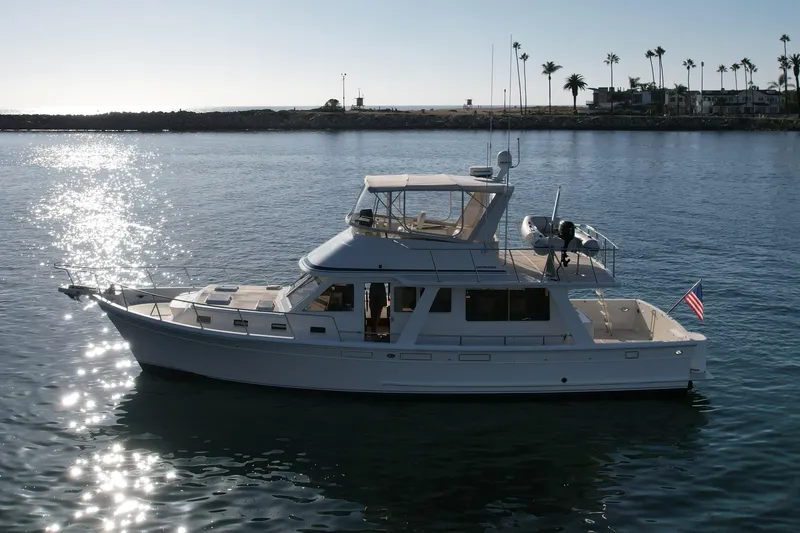 Slide: The Image of 1997 Offshore Yachts 48 Sedan cruising on calm waters under a clear sky. - 8
