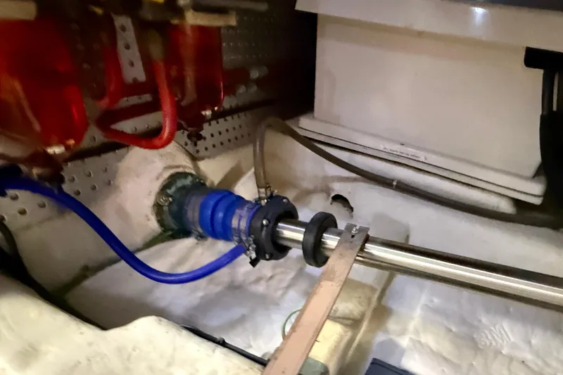 Slide: The Image of Engine room of 1997 Offshore Yachts 48 Sedan, showing shaft and hoses. - 84