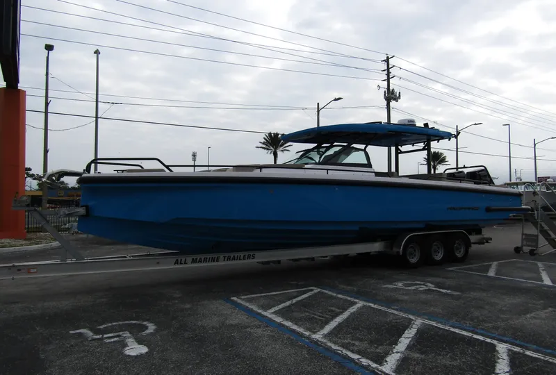Slide: The Image of 2024 Axopar 37 Sun Top boat on trailer in parking lot. - 11
